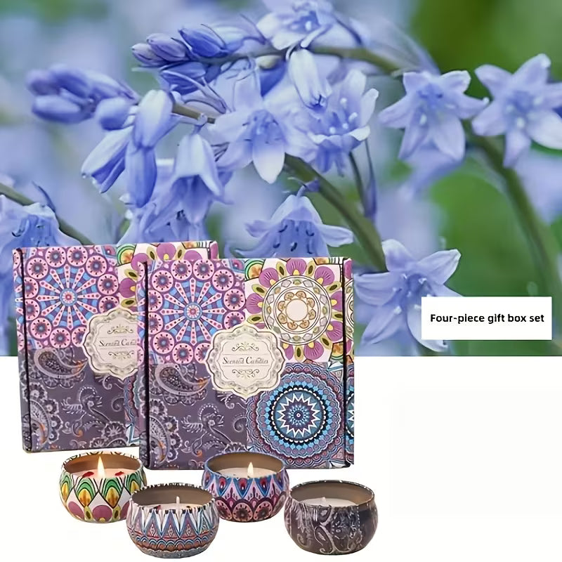 Four patterned tin candles in front of two mandala-print gift boxes, with blue flowers in the background