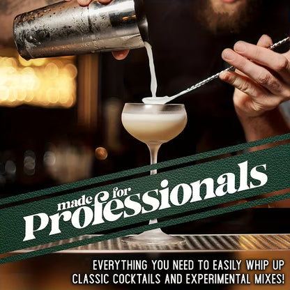 Cocktail being poured from a stainless steel shaker into a coupe glass